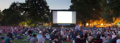 lots of people watching a movie outdoors